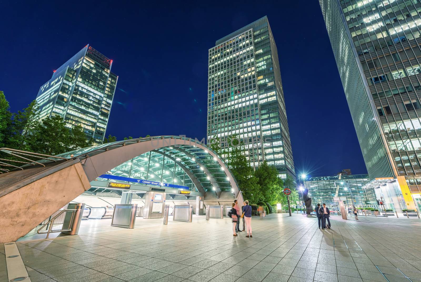 LONDON - JUNE 14, 2015: Lights of Canary Wharf buildings at night. Canary Wharf is the city financial district.