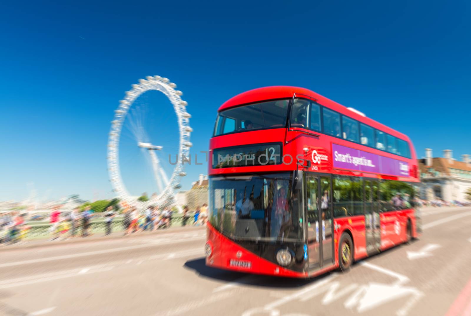 LONDON - JUNE 12, 2015: Fast moving red bus on Westminster Bridge. The London Bus service is one of the largest urban bus networks in the world with 8,000 buses covering 700 routes.