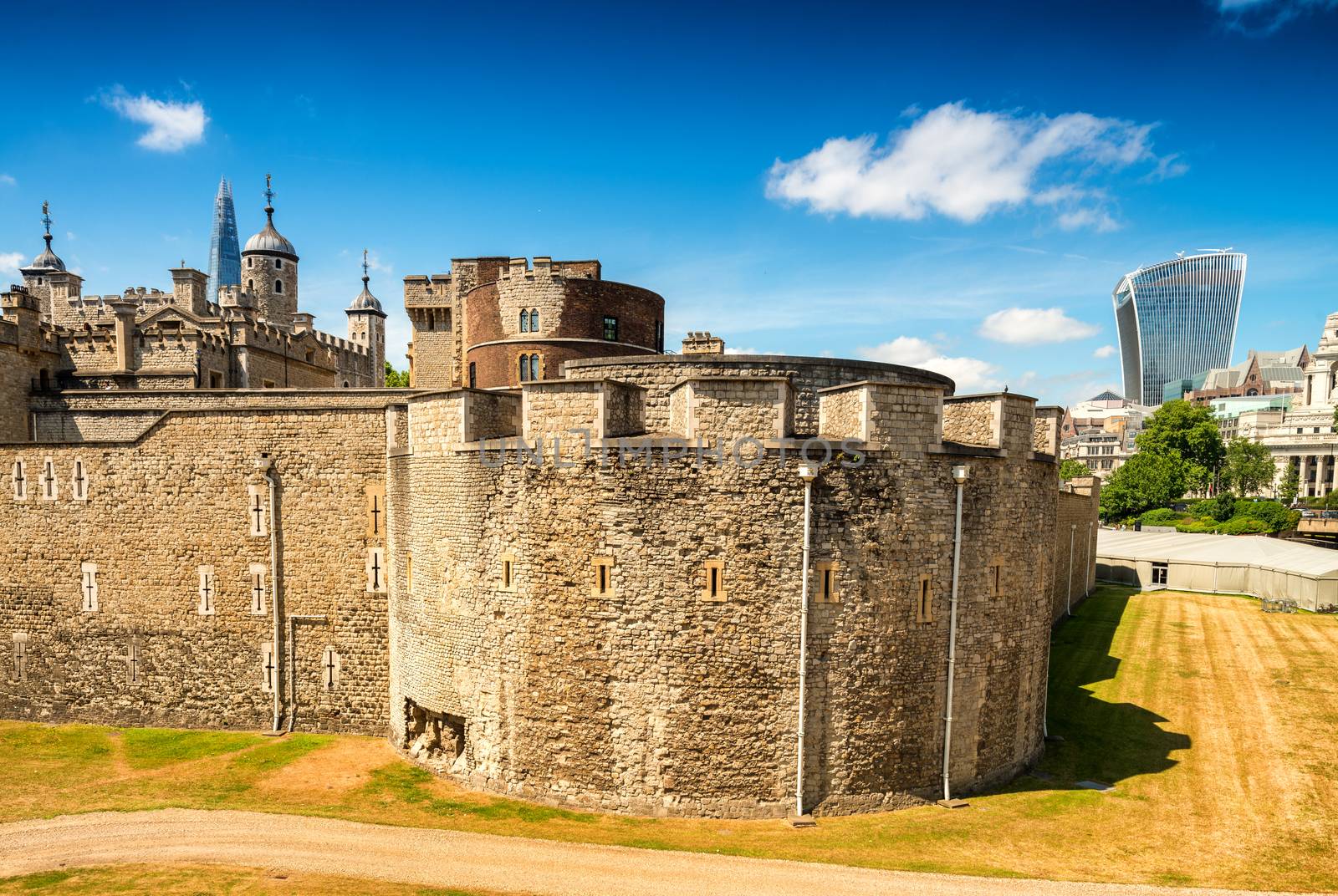 Tower of London ancient complex with City on background by jovannig