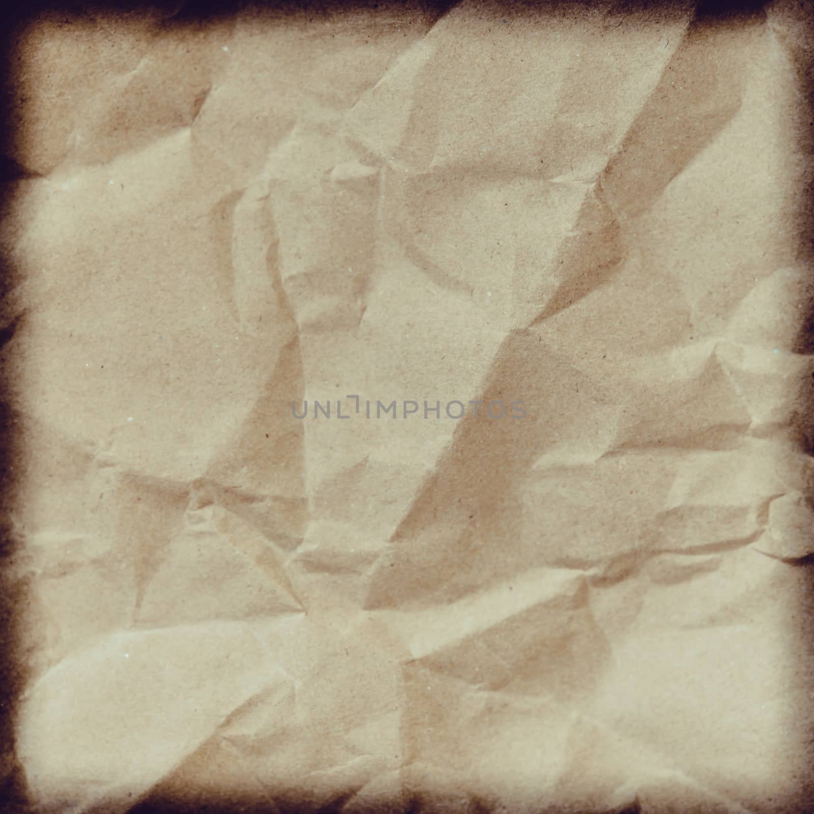 Crumpled paper background vignette space for text or image.Old paper texture