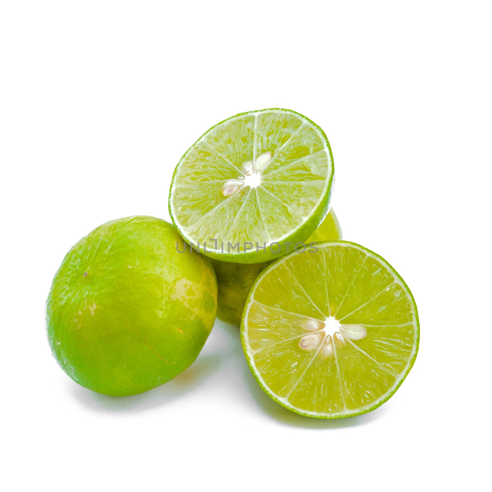 Juicy slices of lime isolated on white background.