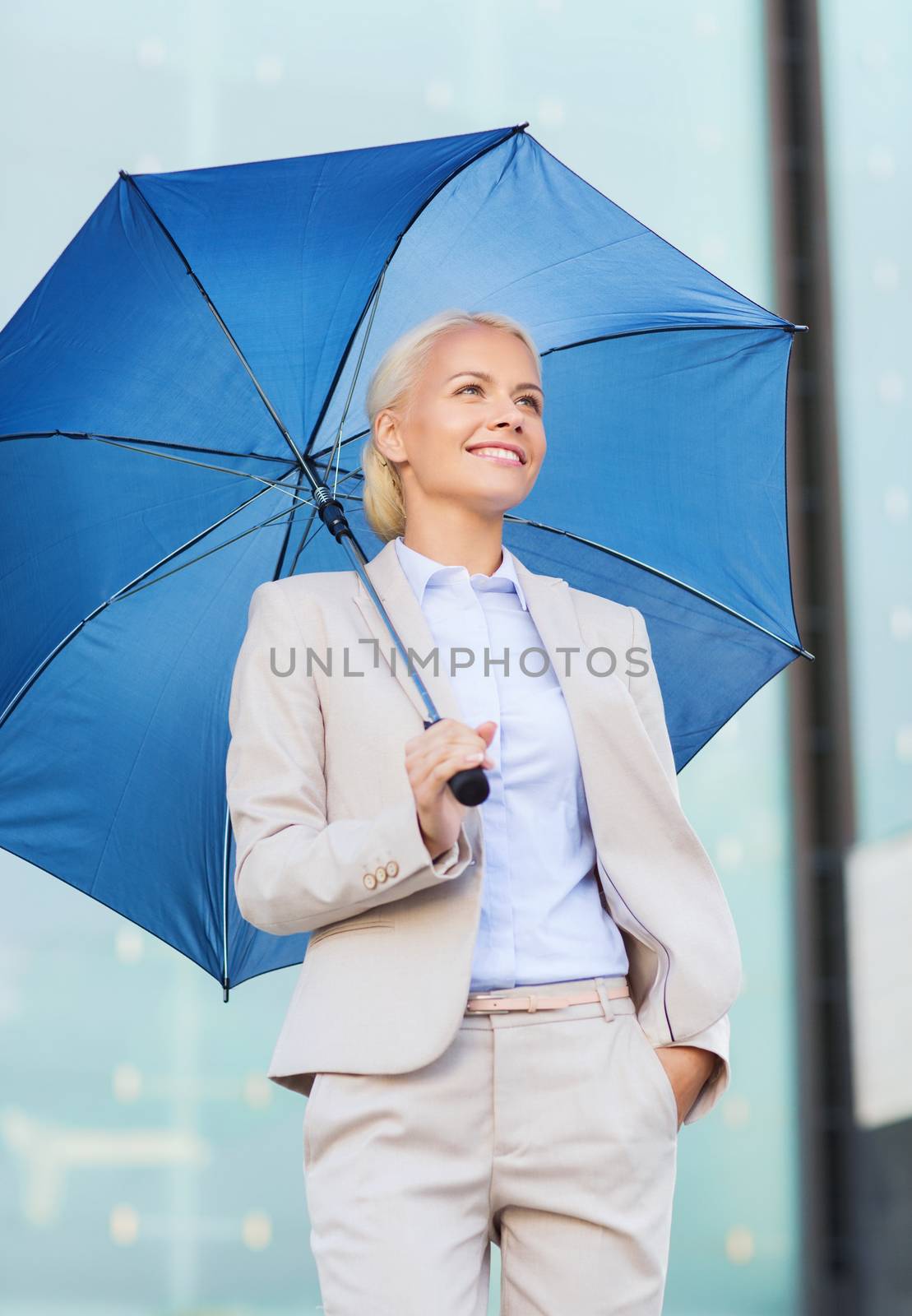business, bad weather and people and concept - young smiling businesswoman with umbrella outdoors