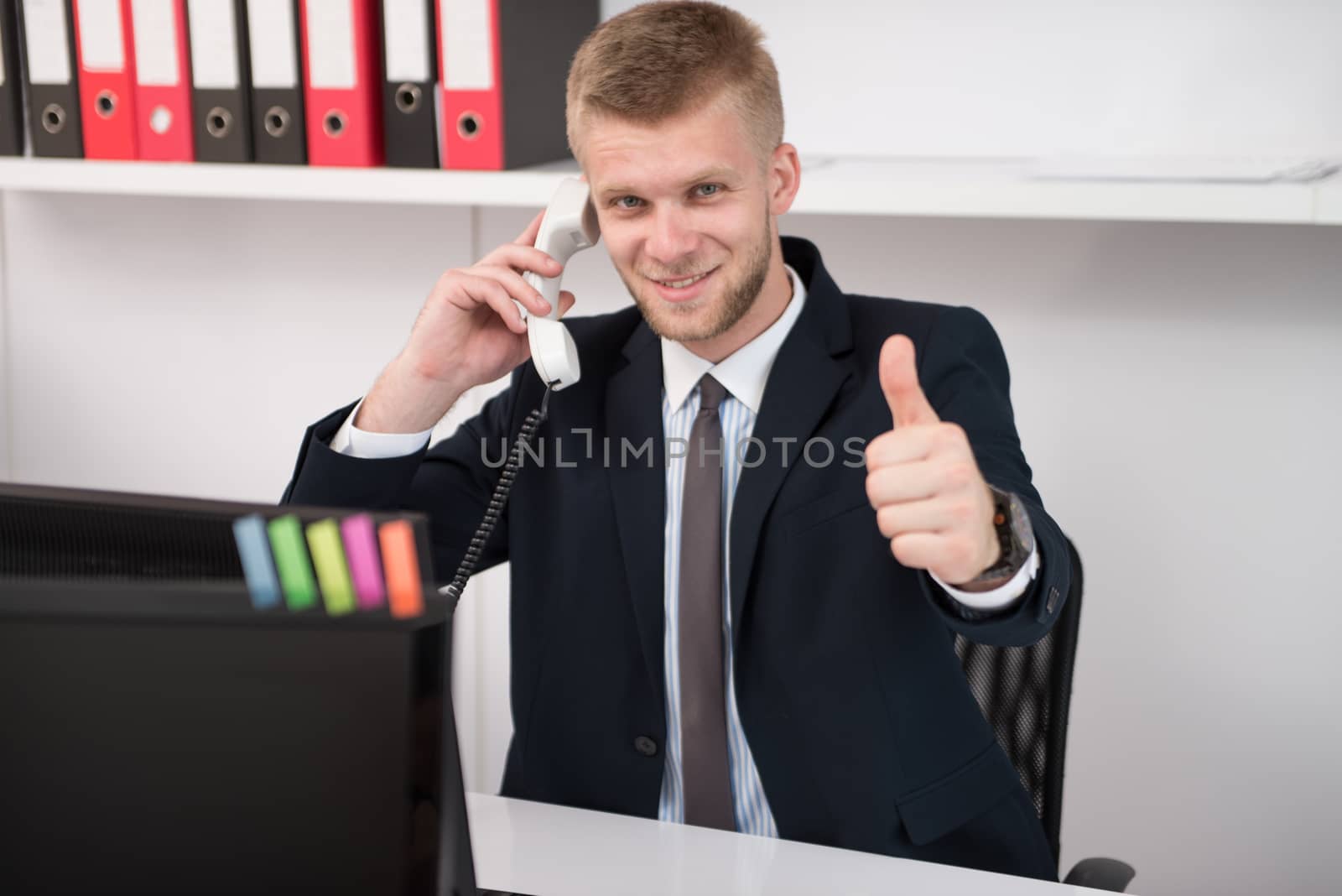 Businessman Showing Ok Sign With His Thumb Up by JalePhoto