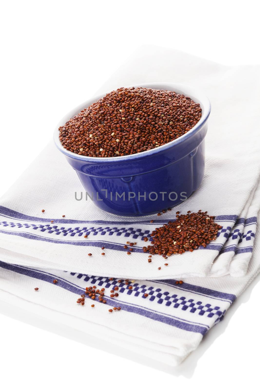 Red quinoa seeds in bowl isolated on white background. Healthy eating.