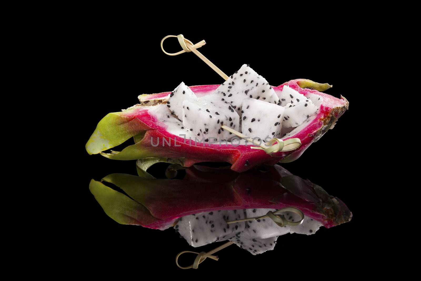 Dragon fruit isolated on black background. Tropical fruit salad.