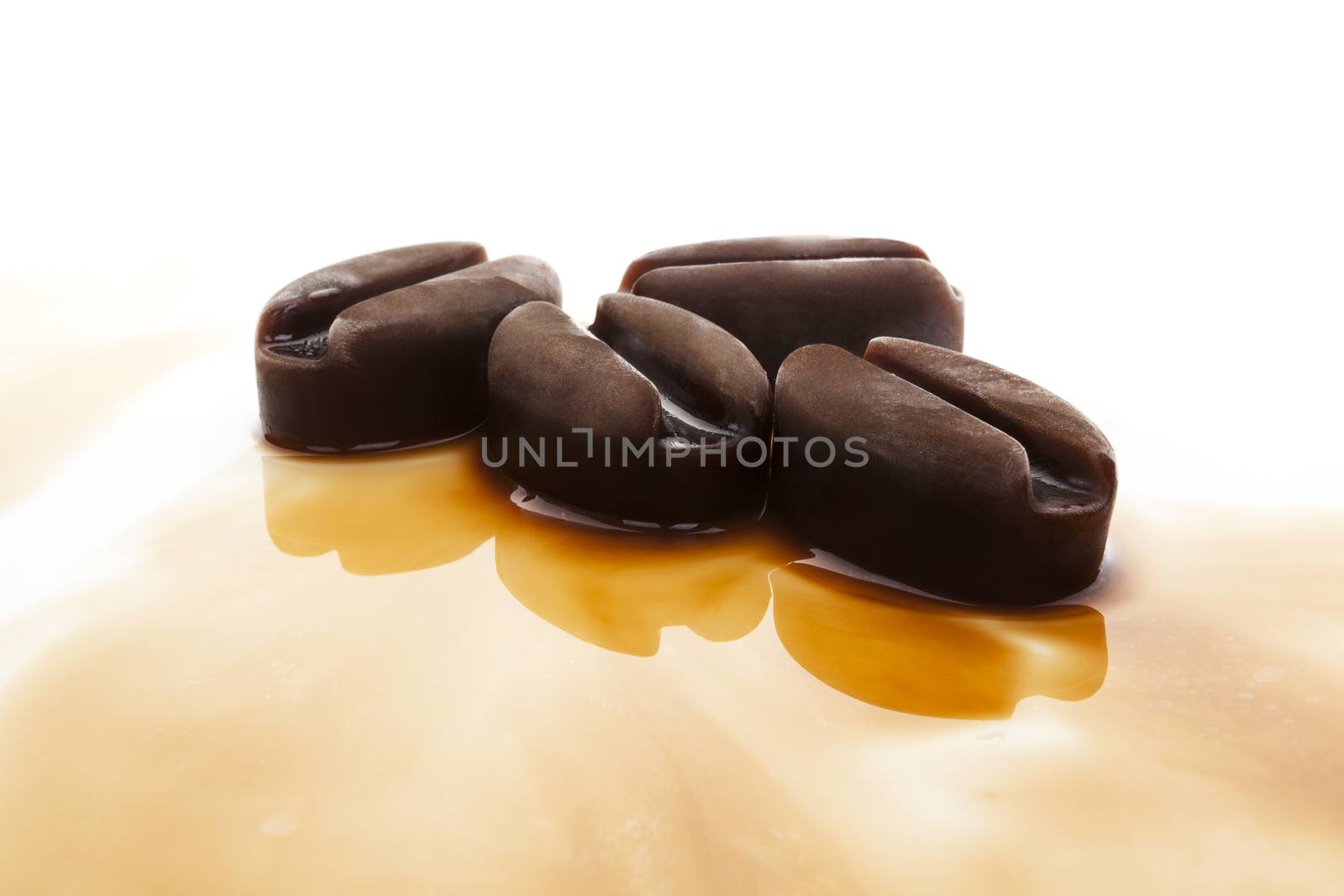 Ice coffee. Frozen coffee in coffee beans form on white background.