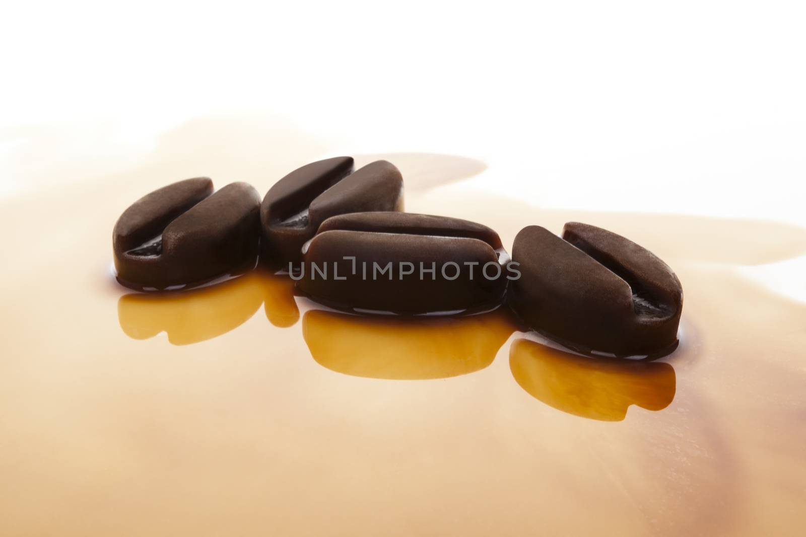 Ice coffee. Frozen coffee in coffee beans form on white background.