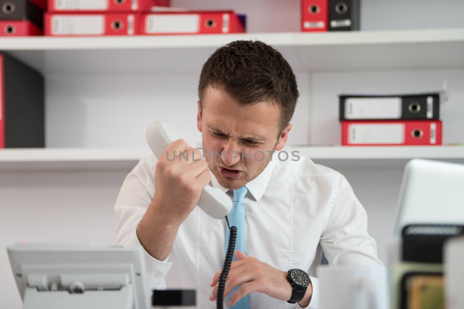 Angry Businessman Talking On The Phone by JalePhoto