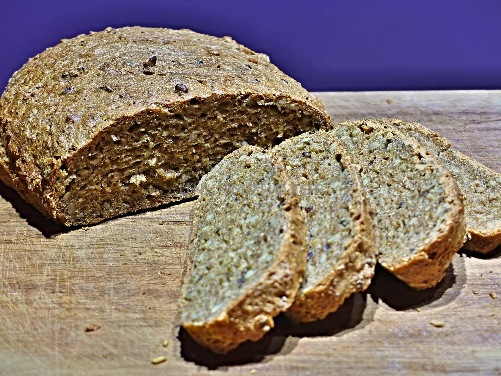 Freshly baked homemade brown bread with four slices