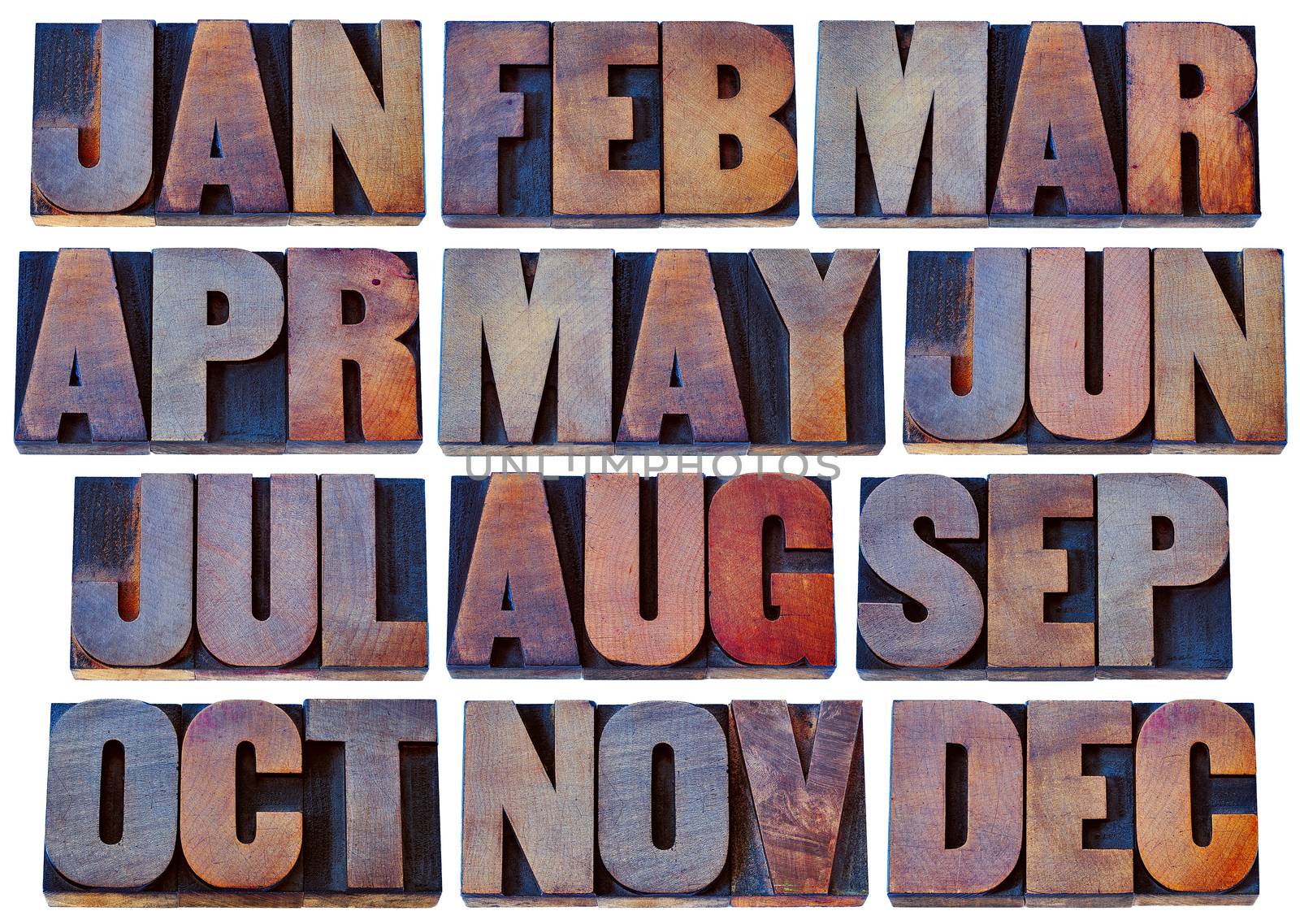 12 months from January to December - a collage of isolated 3 letter symbols in grunge letterpress wood type blocks stained by inks