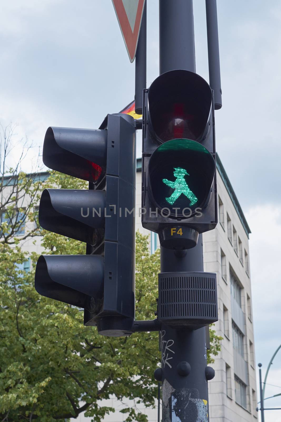 BERLIN, GERMANY - JULY 08: Detail of pedestrian traffic light showing emblematic Berlin green man. July 08, 2015 in Berlin.