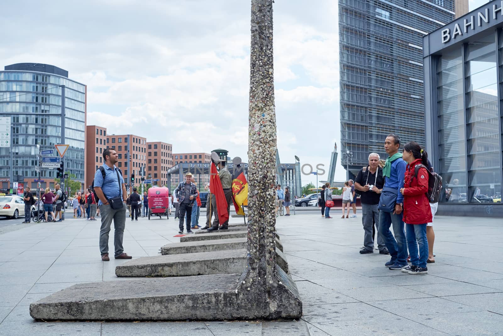 BERLIN, GERMANY - JULY 08: Tourists looking at remaining segments of the wall in central East Berlin. July 08, 2015 in Berlin.