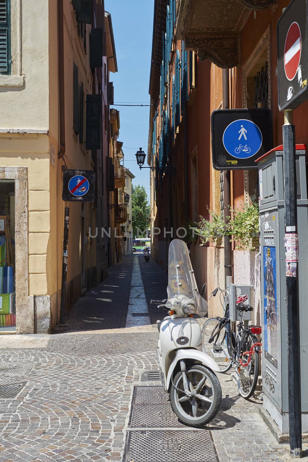VERONA, ITALY - JULY 11: Narrow alley in Verona with scooter parked. July 11, 2015 in Verona.