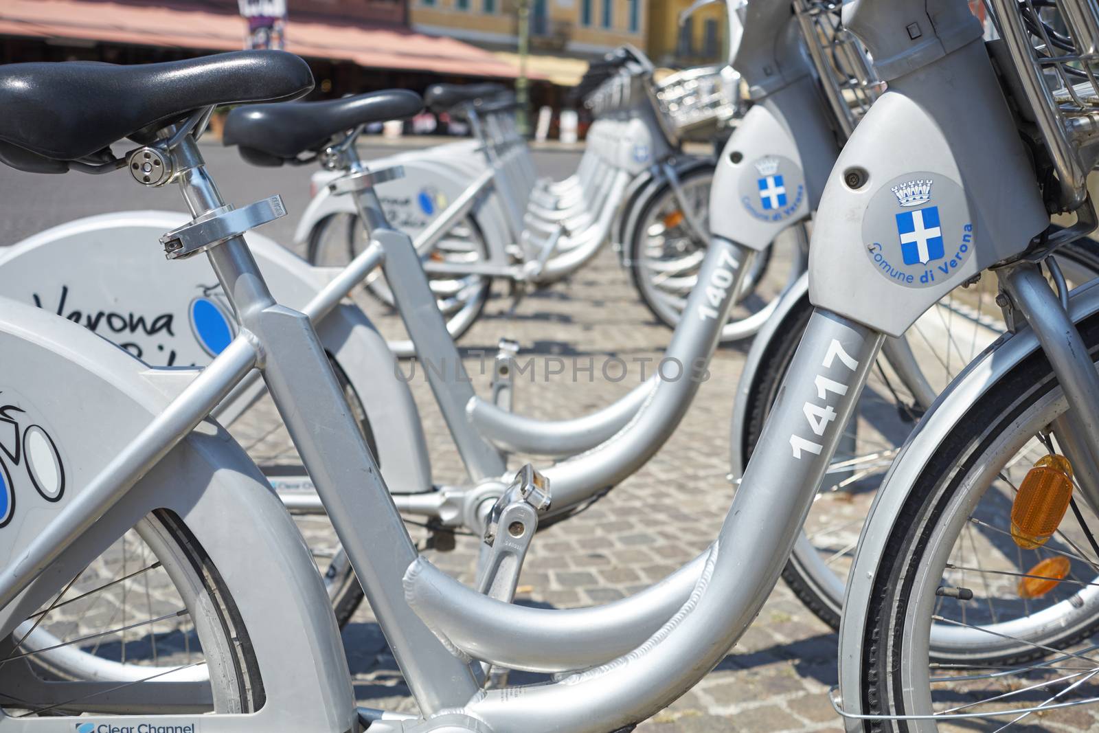 VERONA, ITALY - JULY 11: Low angle cropped shot the city's cycle hire bicycles parked in line. July 11, 2015 in Verona.