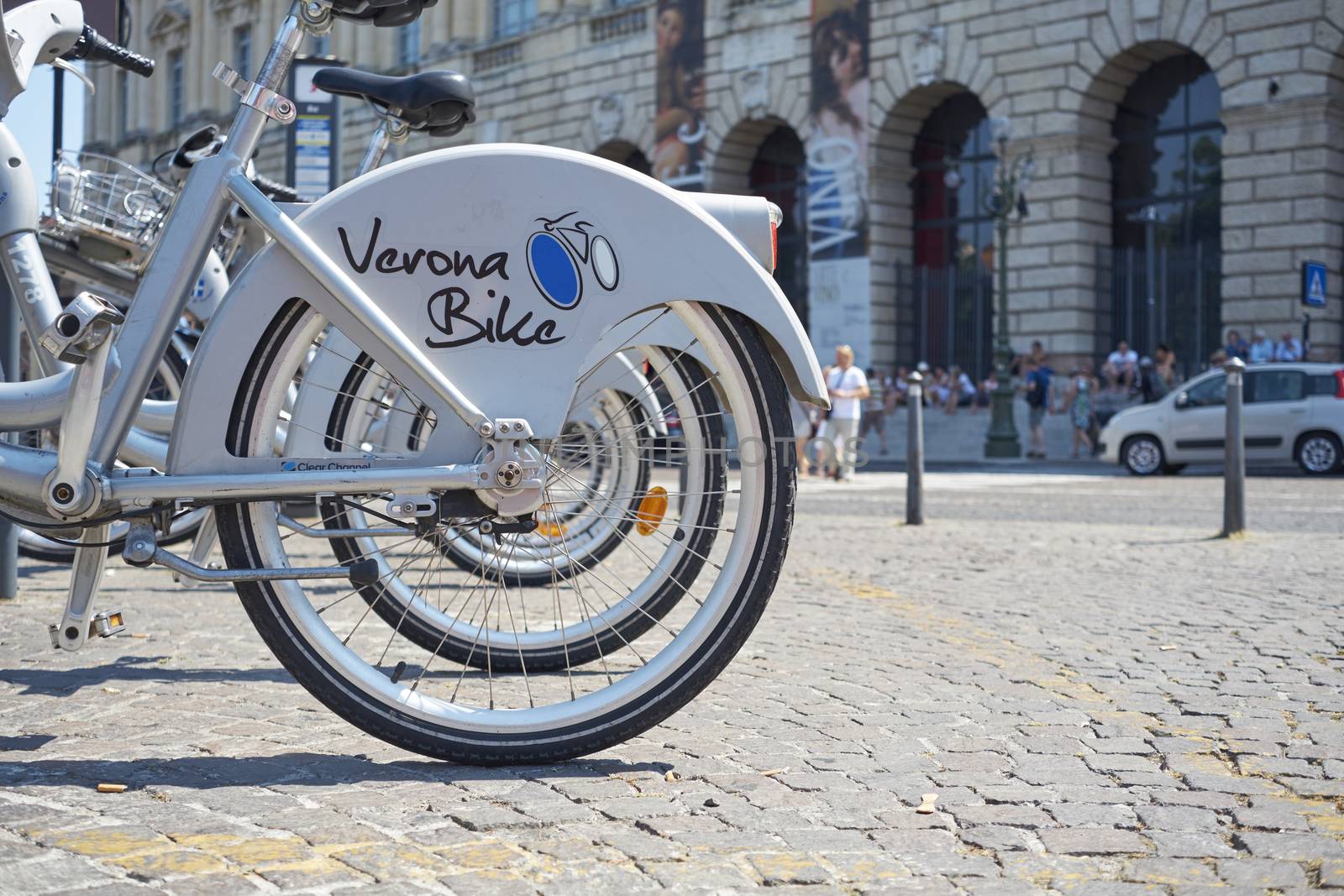VERONA, ITALY - JULY 11: Low angle cropped shot the city's cycle hire bicycles parked in line. July 11, 2015 in Verona.