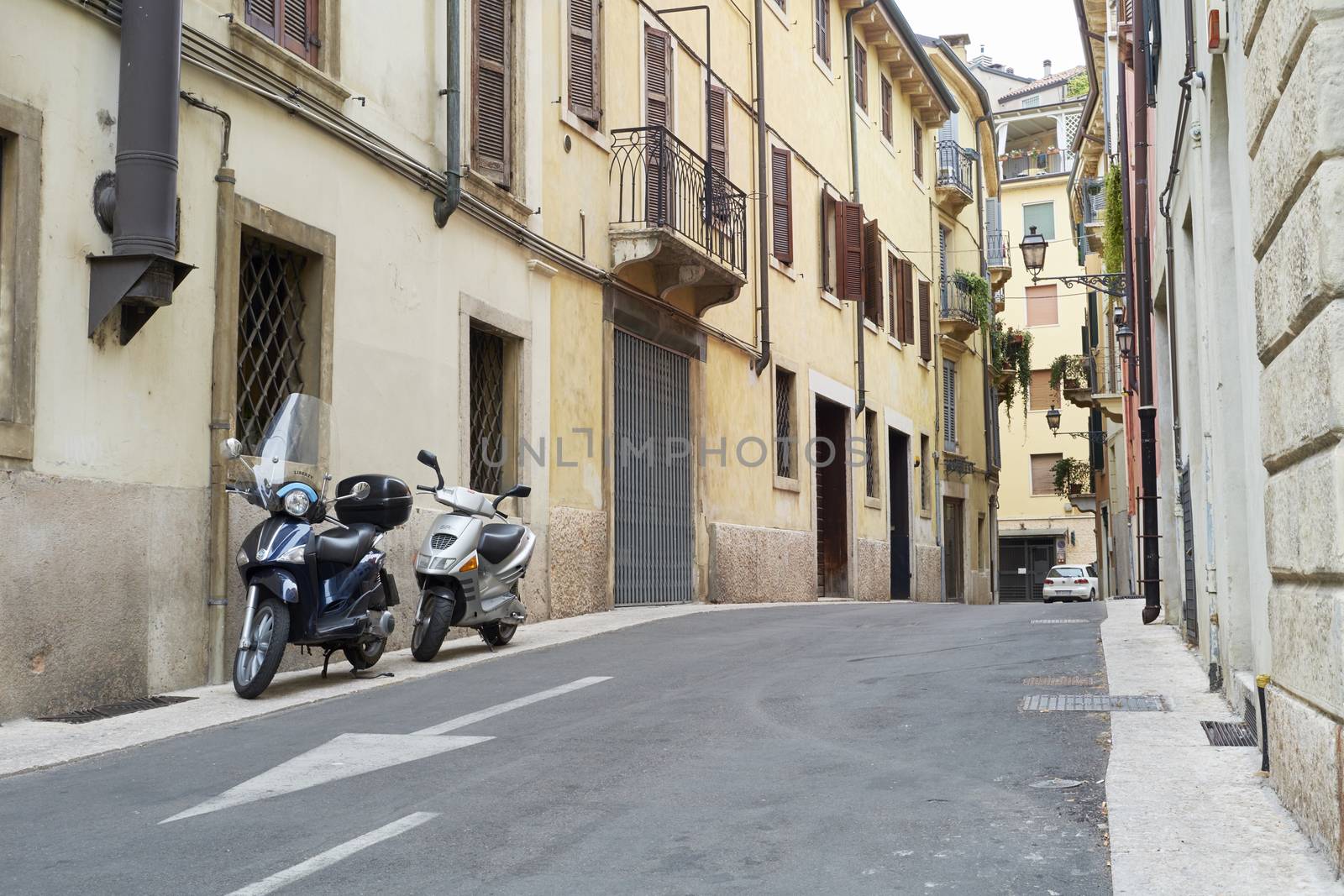 VERONA, ITALY - JULY 13: Low angle shot of street with scooters parked. July 13, 2015 in Verona.
