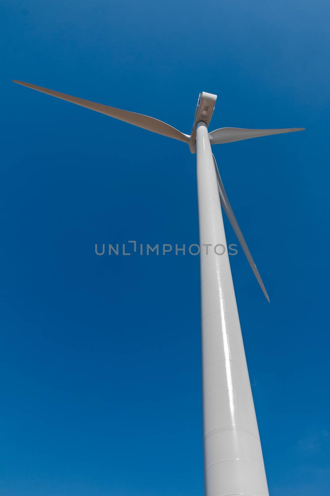 perspective of wind turbine in blue sky