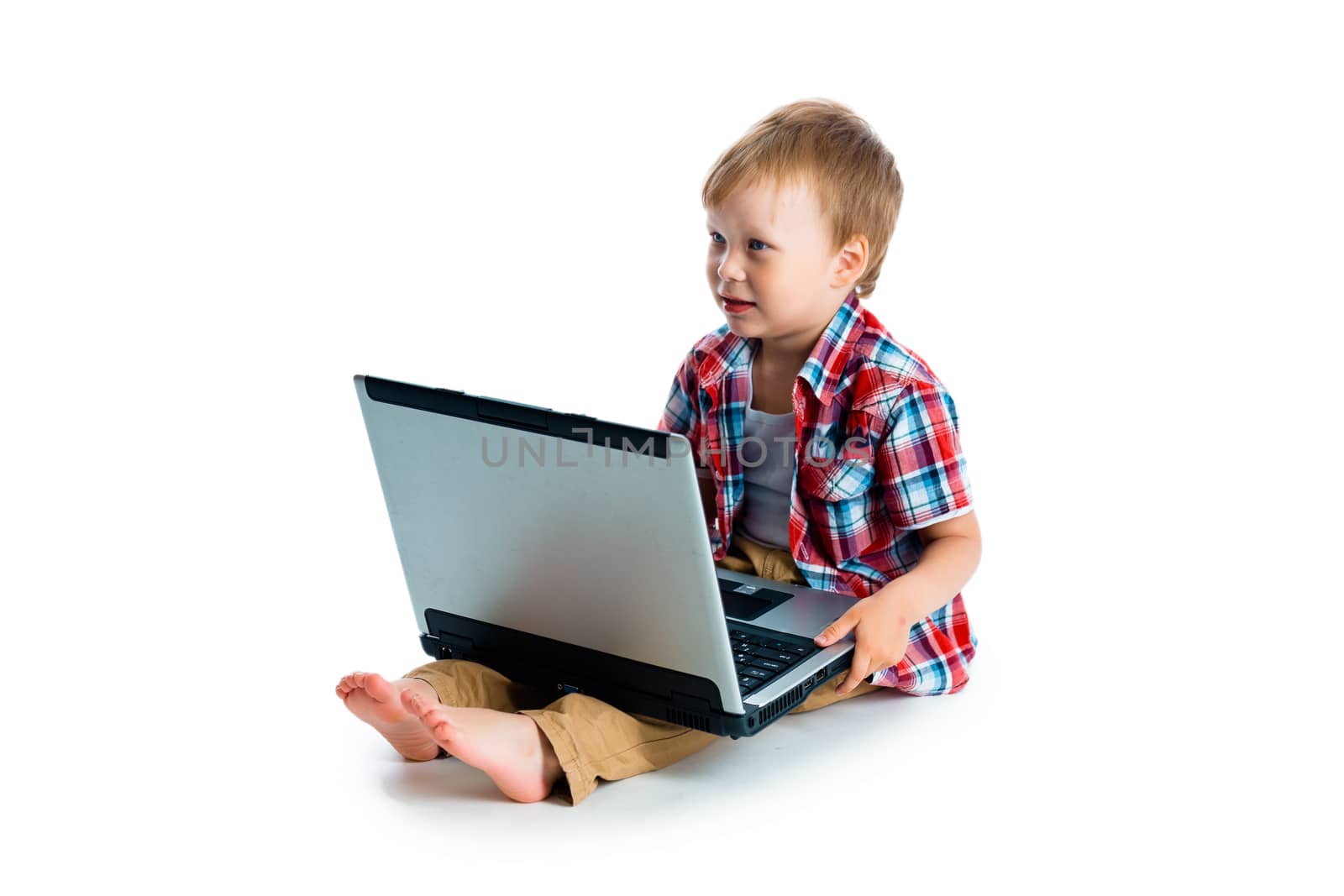 The little blue-eyed boy with a laptop on a white background