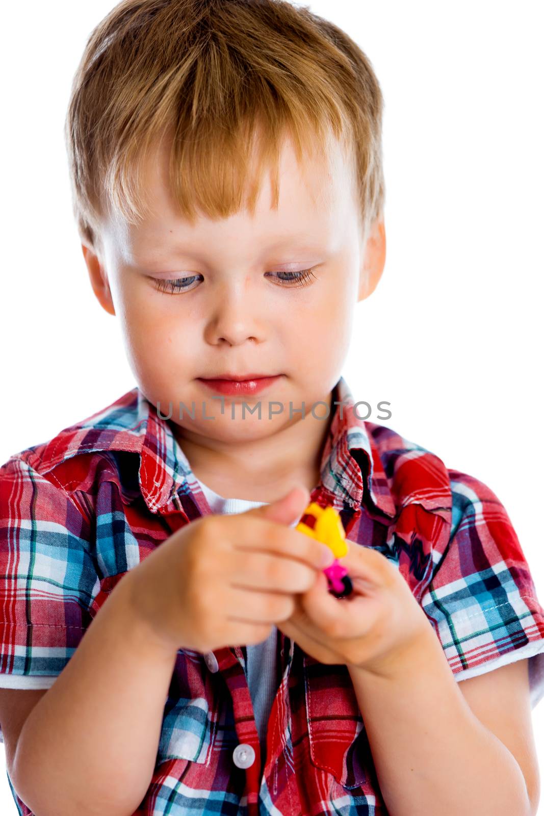 Little boy with a toy on a white background