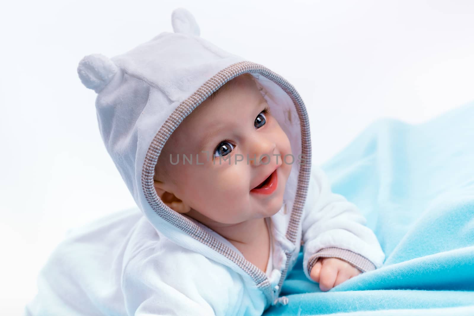 Happy Baby in the hood on a blue blanket