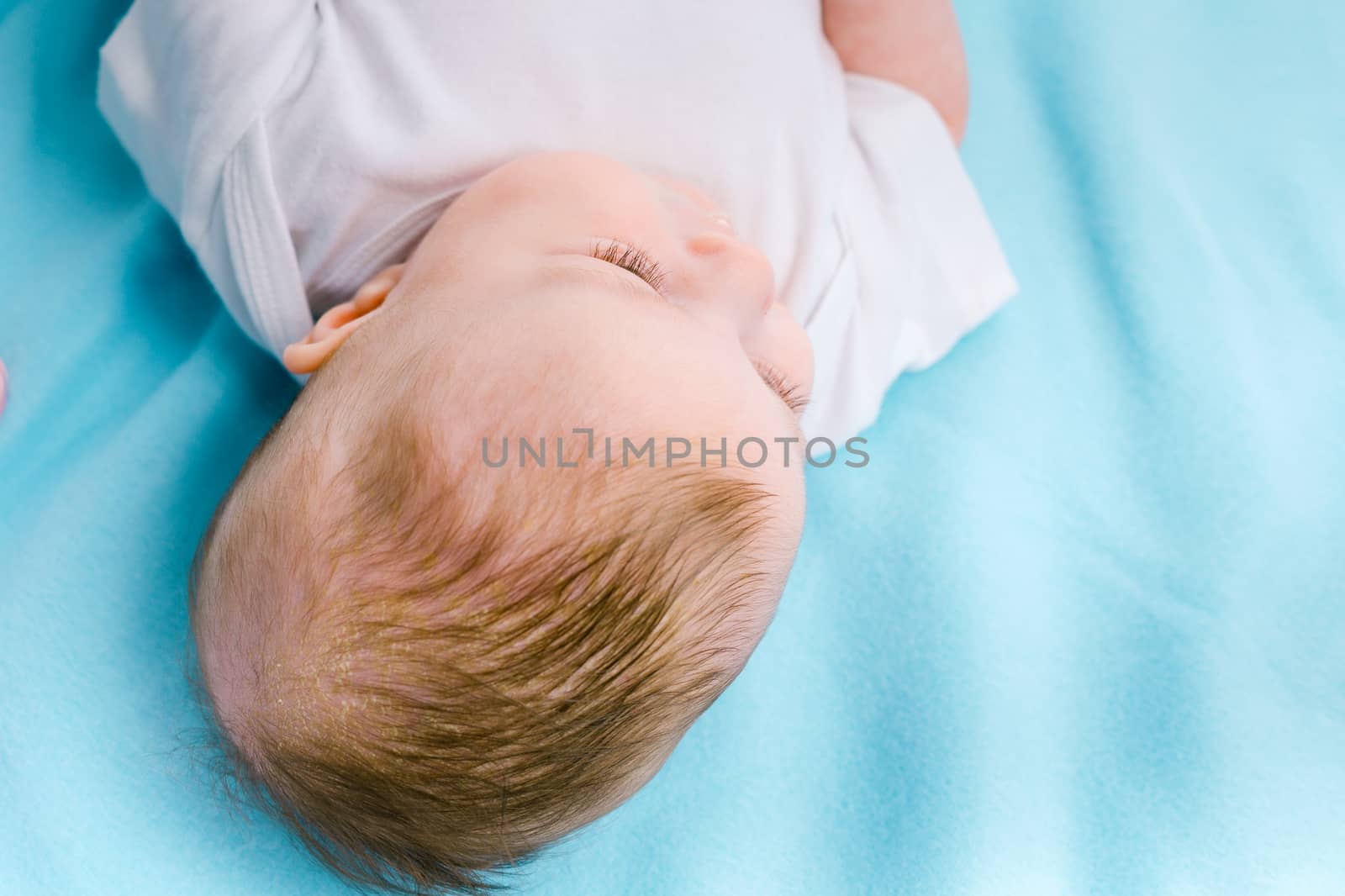 beautiful baby on a blue blanket. studio