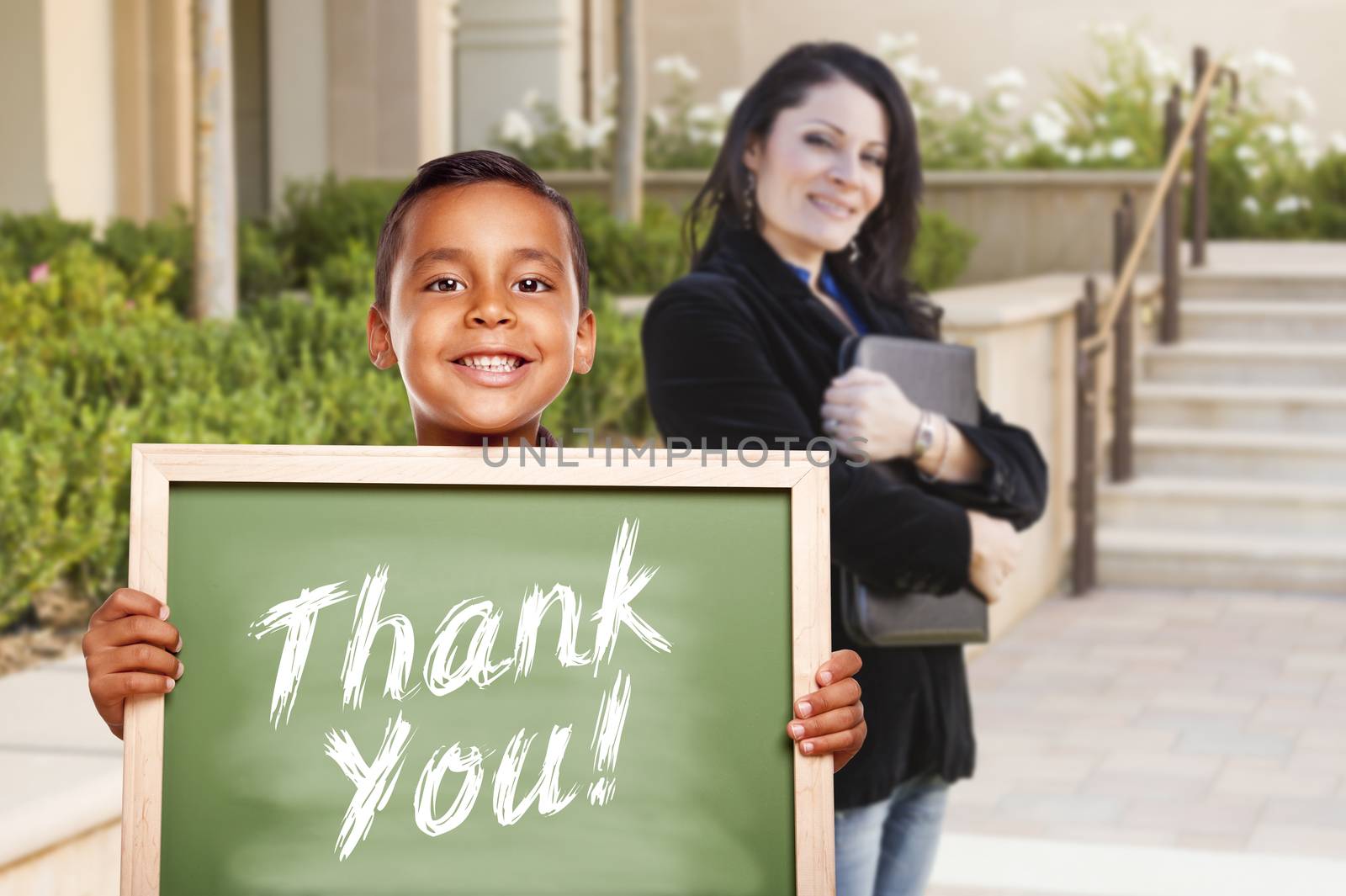 Boy Holding Thank You Chalk Board with Teacher Behind by Feverpitched