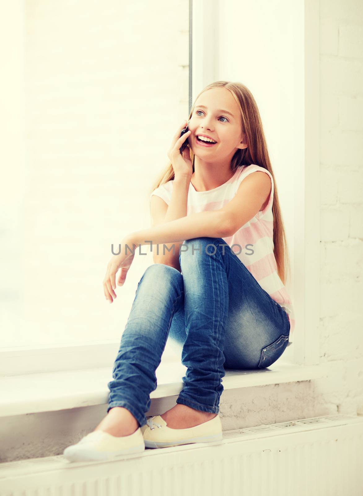 girl with smartphone at school by dolgachov