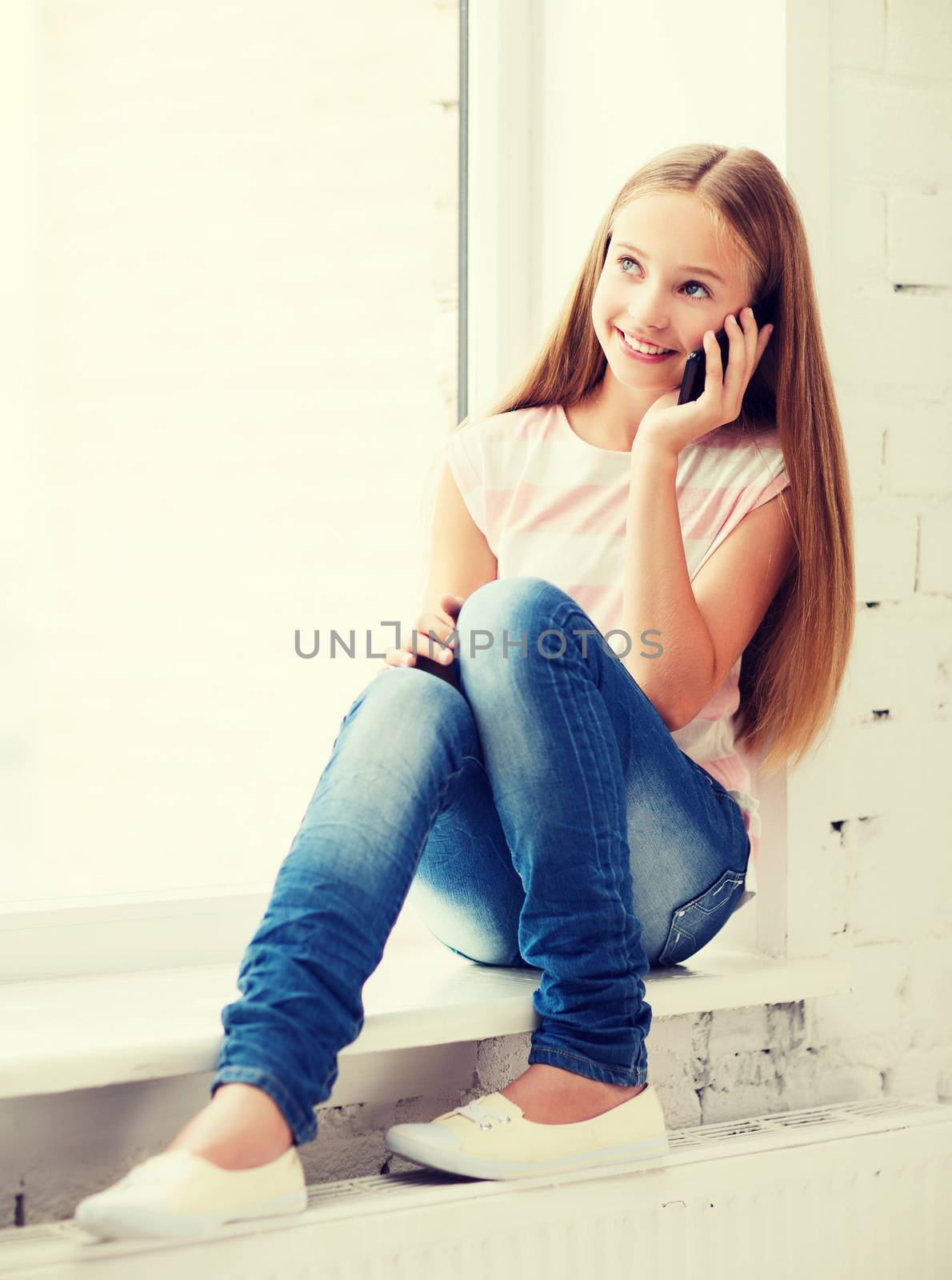 girl with smartphone at school by dolgachov