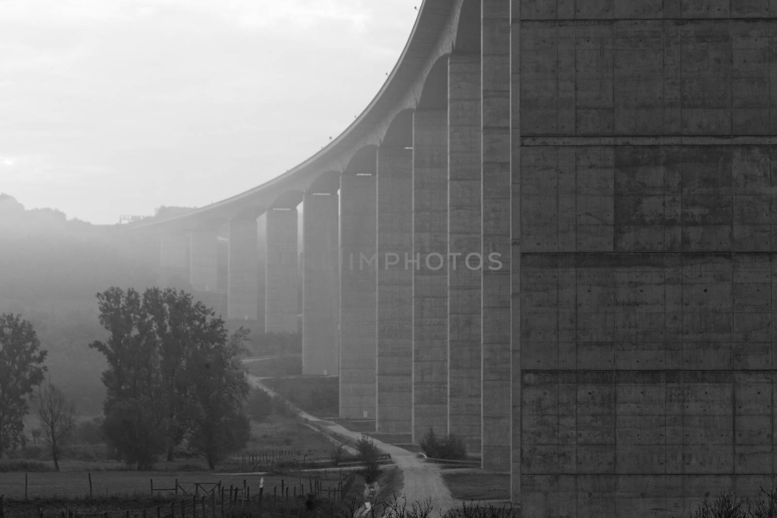 Large highway viaduct with foggy sunrise on autumn