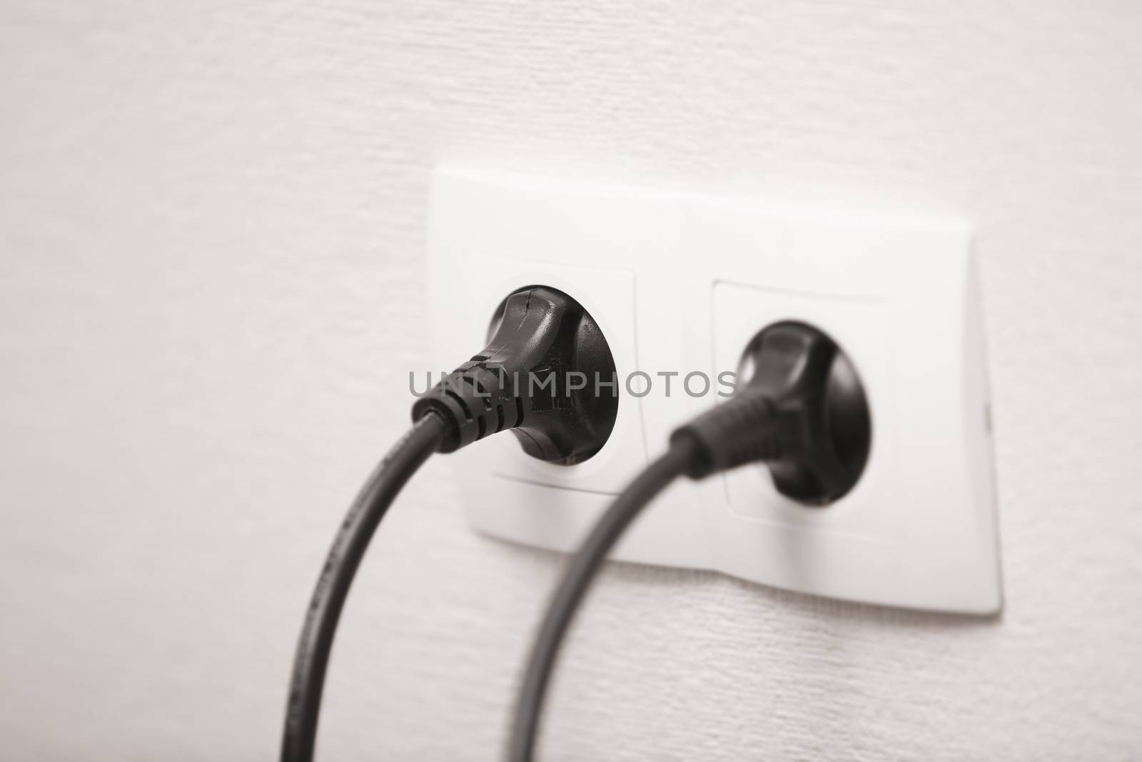 Close-up view of electric outlets with power cables