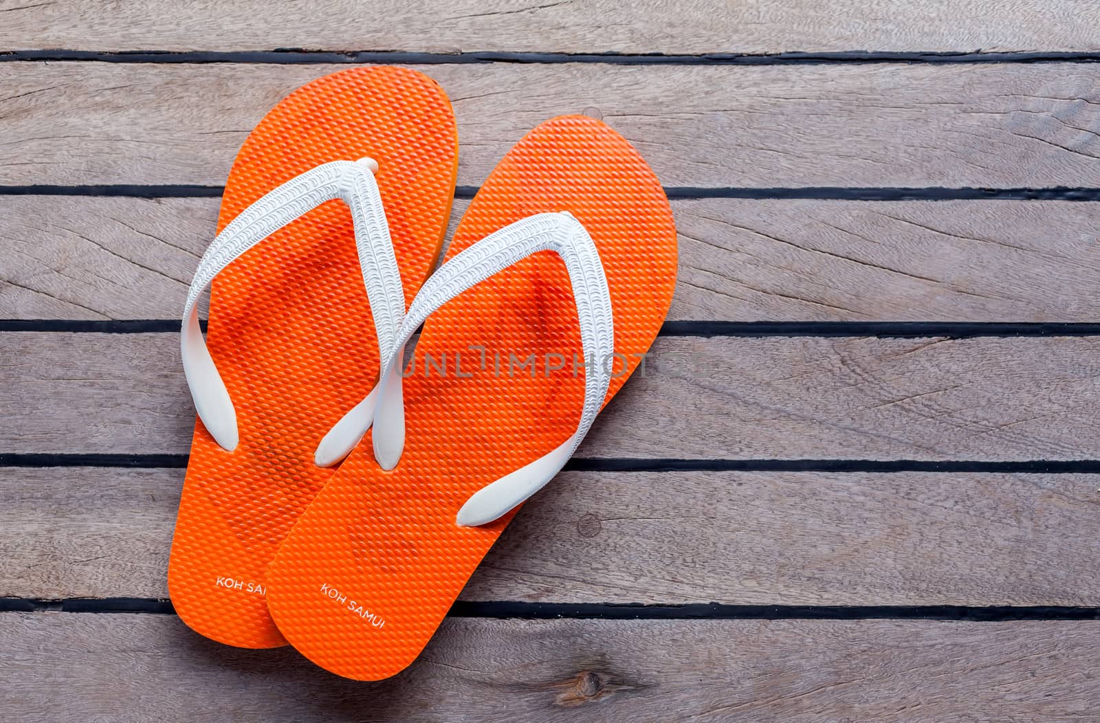 Flip flops on sailing yacht floor for summer background .