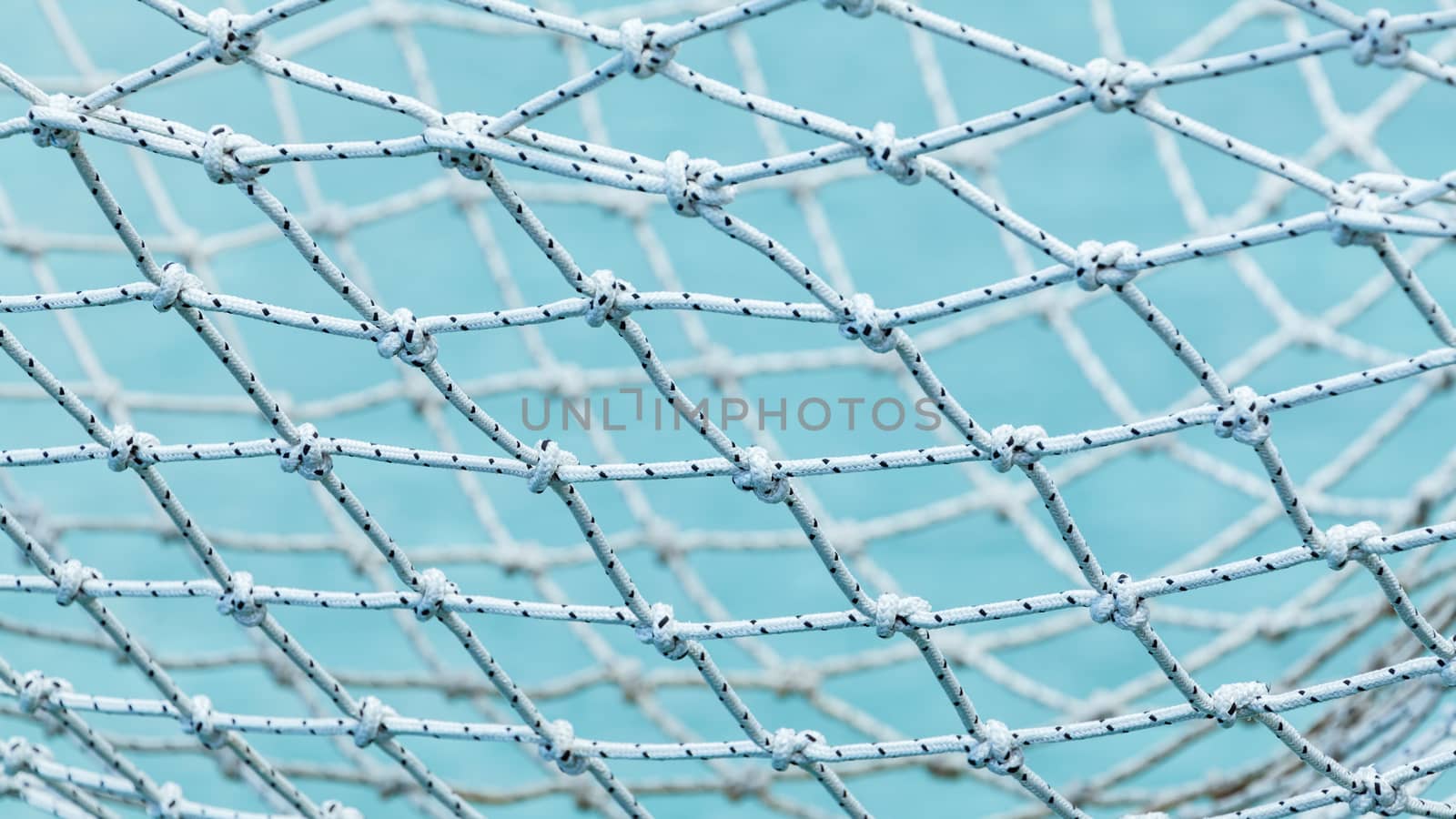 Yacht safety nets of sailing yacht and ocean background.