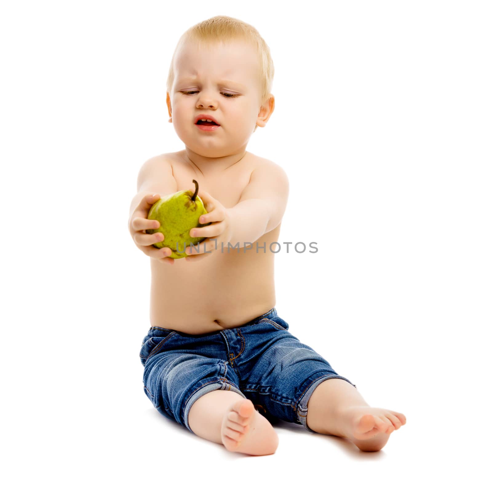 Little dissatisfied boy disclaims pears on a white background