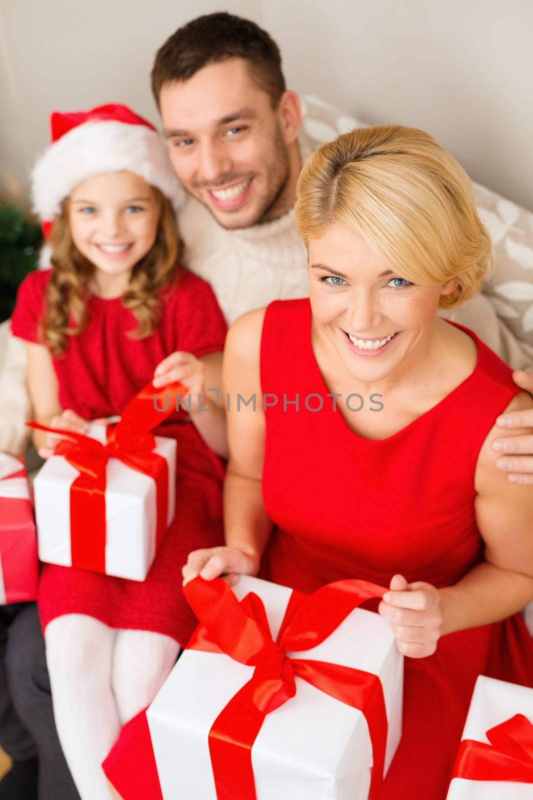 family, christmas, x-mas, happiness and people concept - happy family opening gift boxes