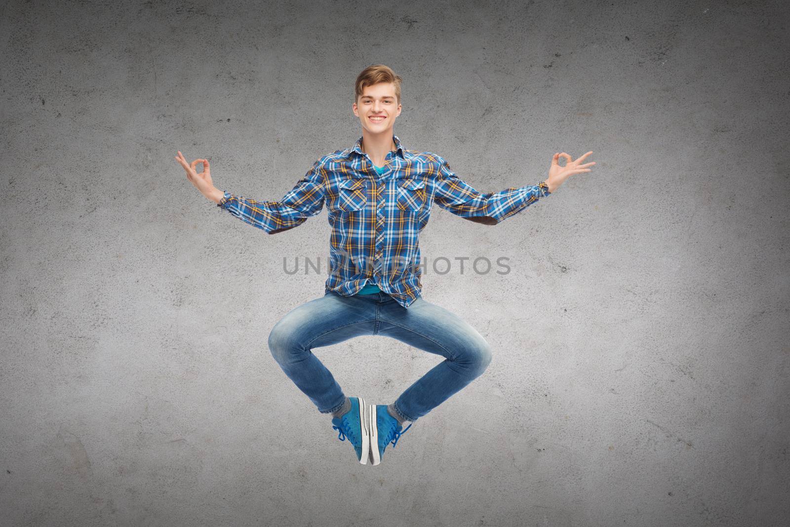 smiling young man jumping in air by dolgachov