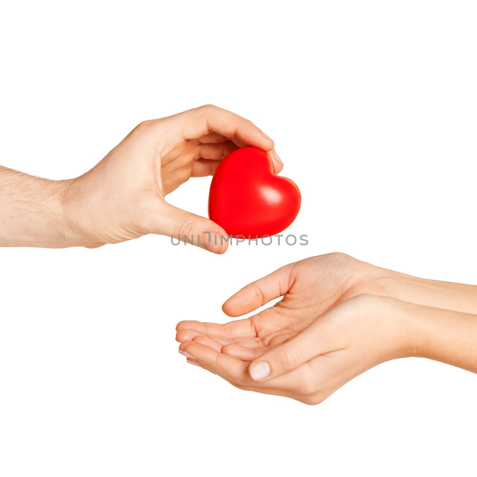 man hand giving red heart to woman by dolgachov