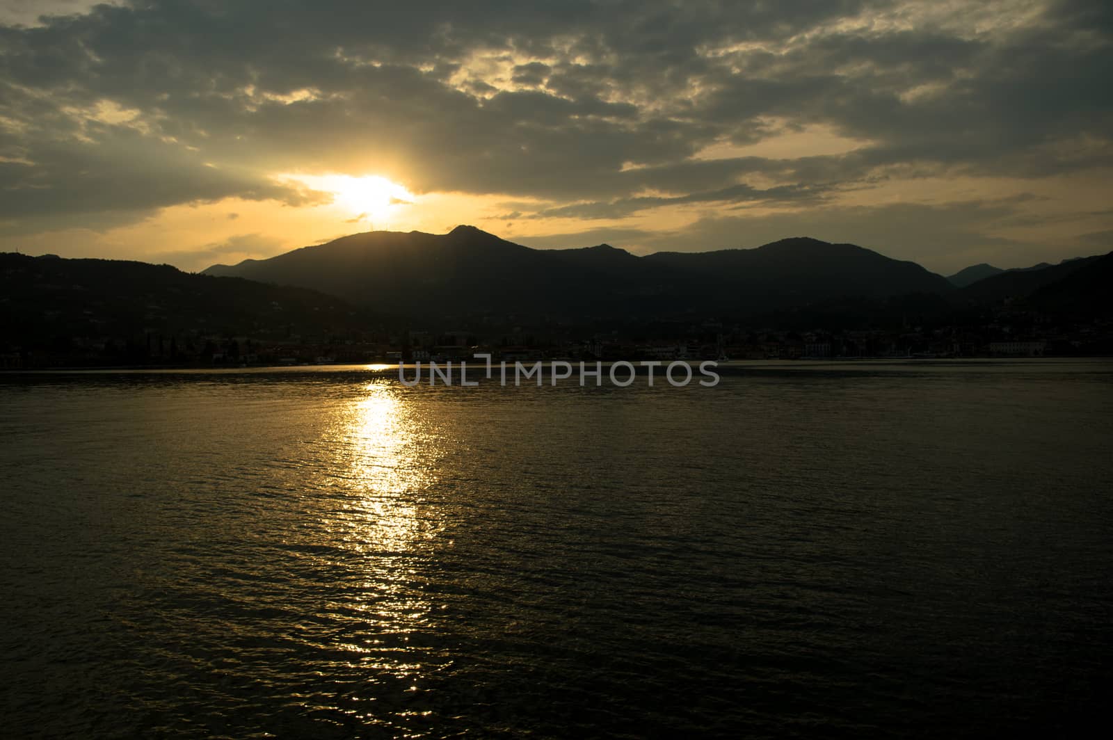 sunset through the clouds over Lake Garda