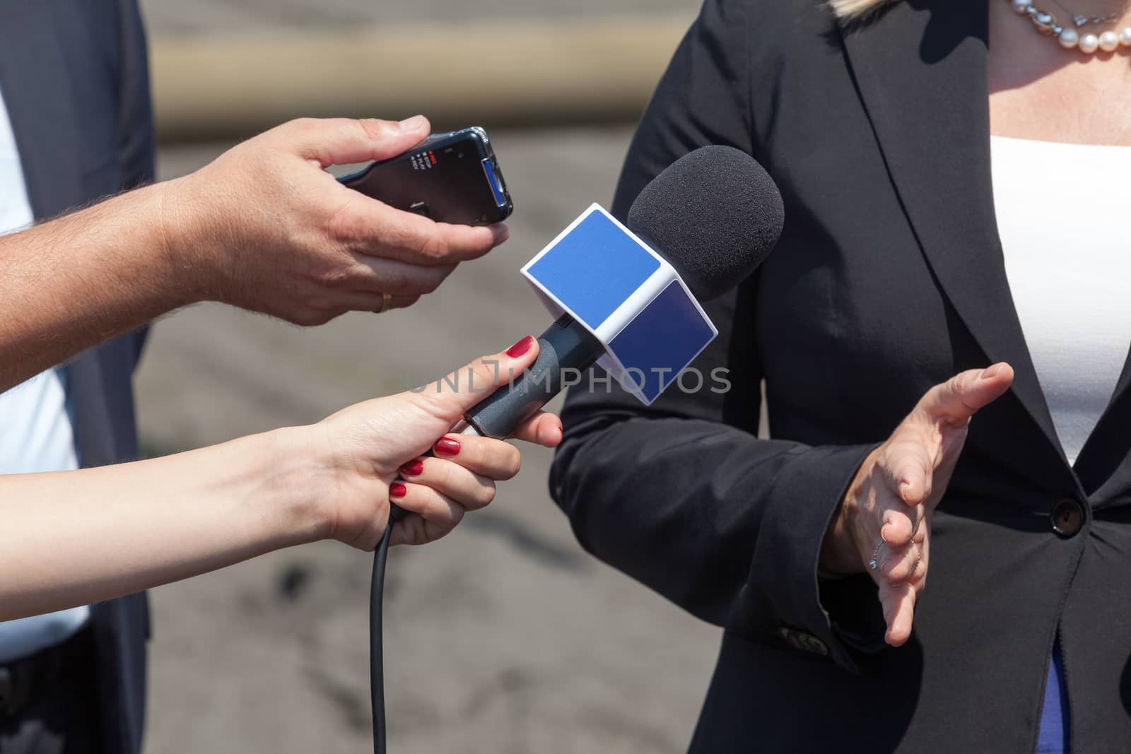 Journalists making interview with business woman by wellphoto