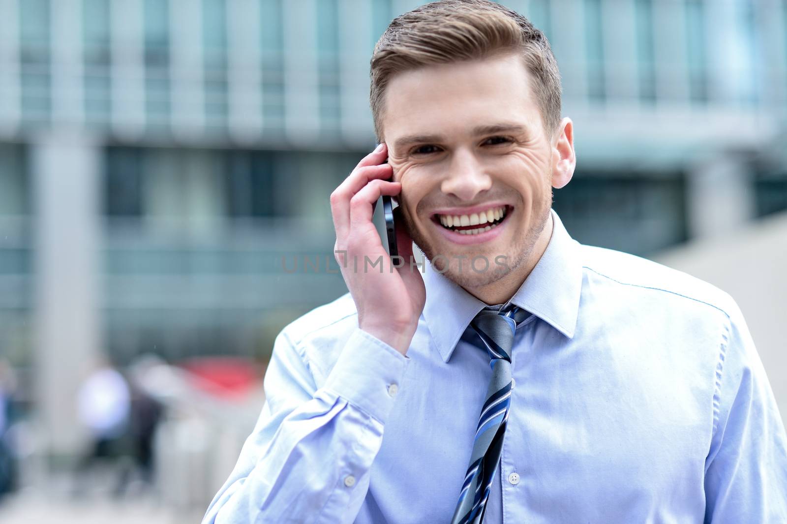 Cheerful male executive talking on his mobile