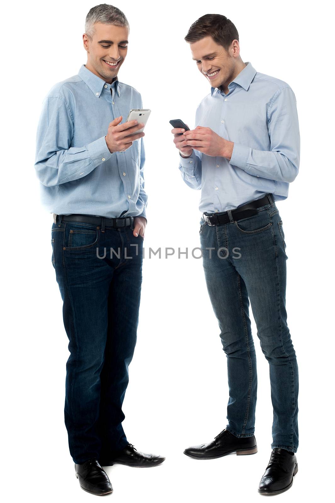 Casual men operating their new mobile phone