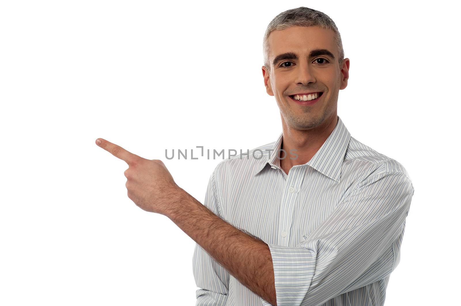 Image of a happy young man pointing to copy space