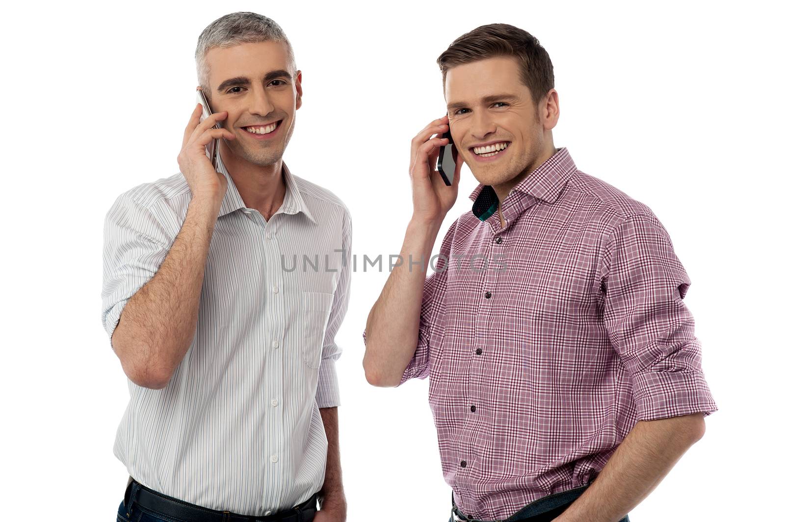 Casual smiling men communicate via cell phone