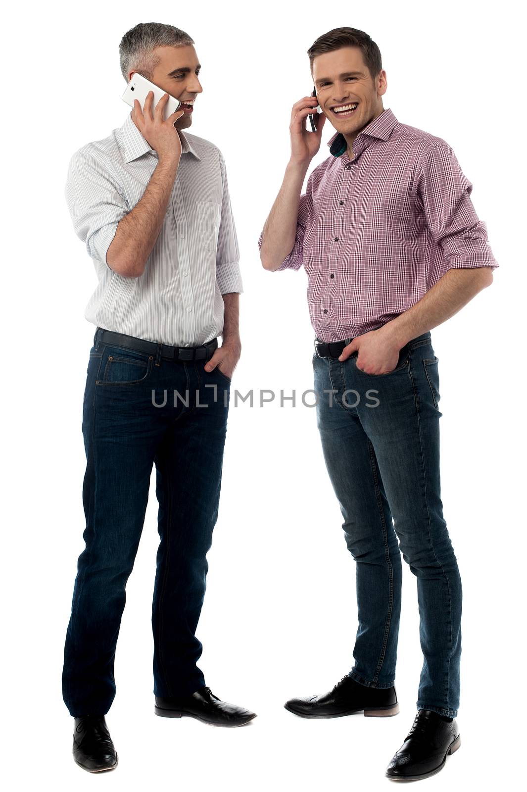 Full length of handsome men talking on cell phone