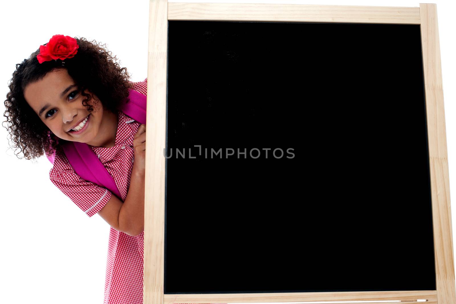 Little girl posing behind the black board