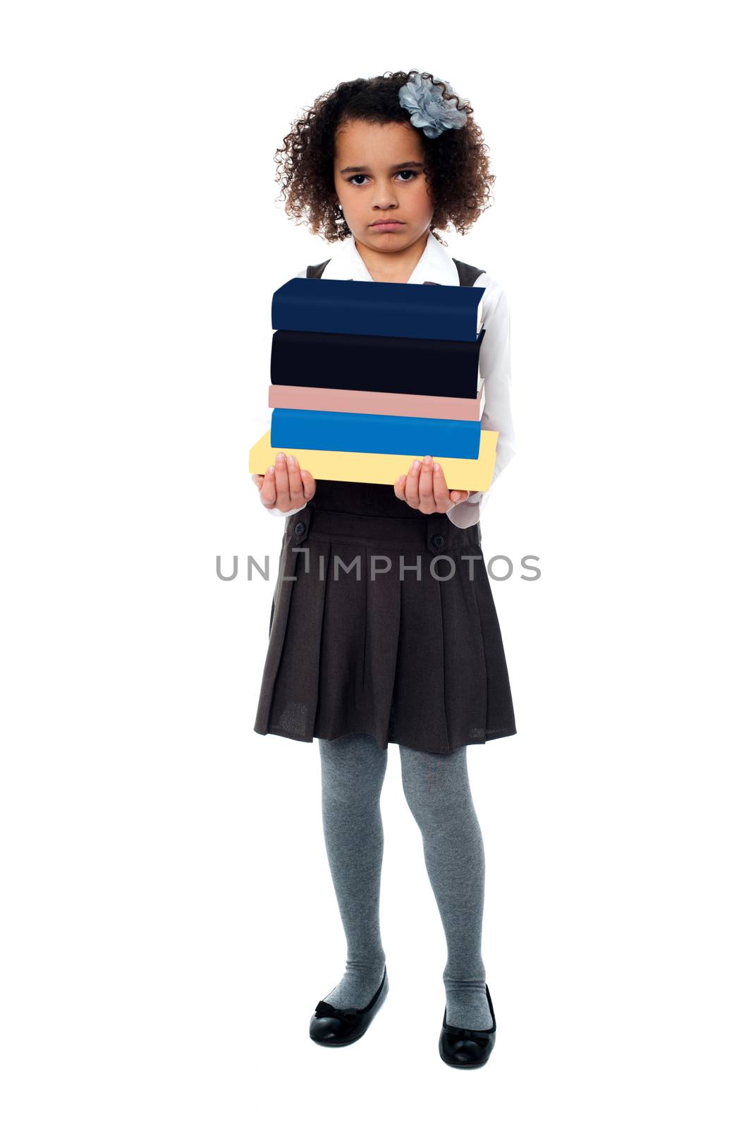 Unhappy girl holding stack of school books