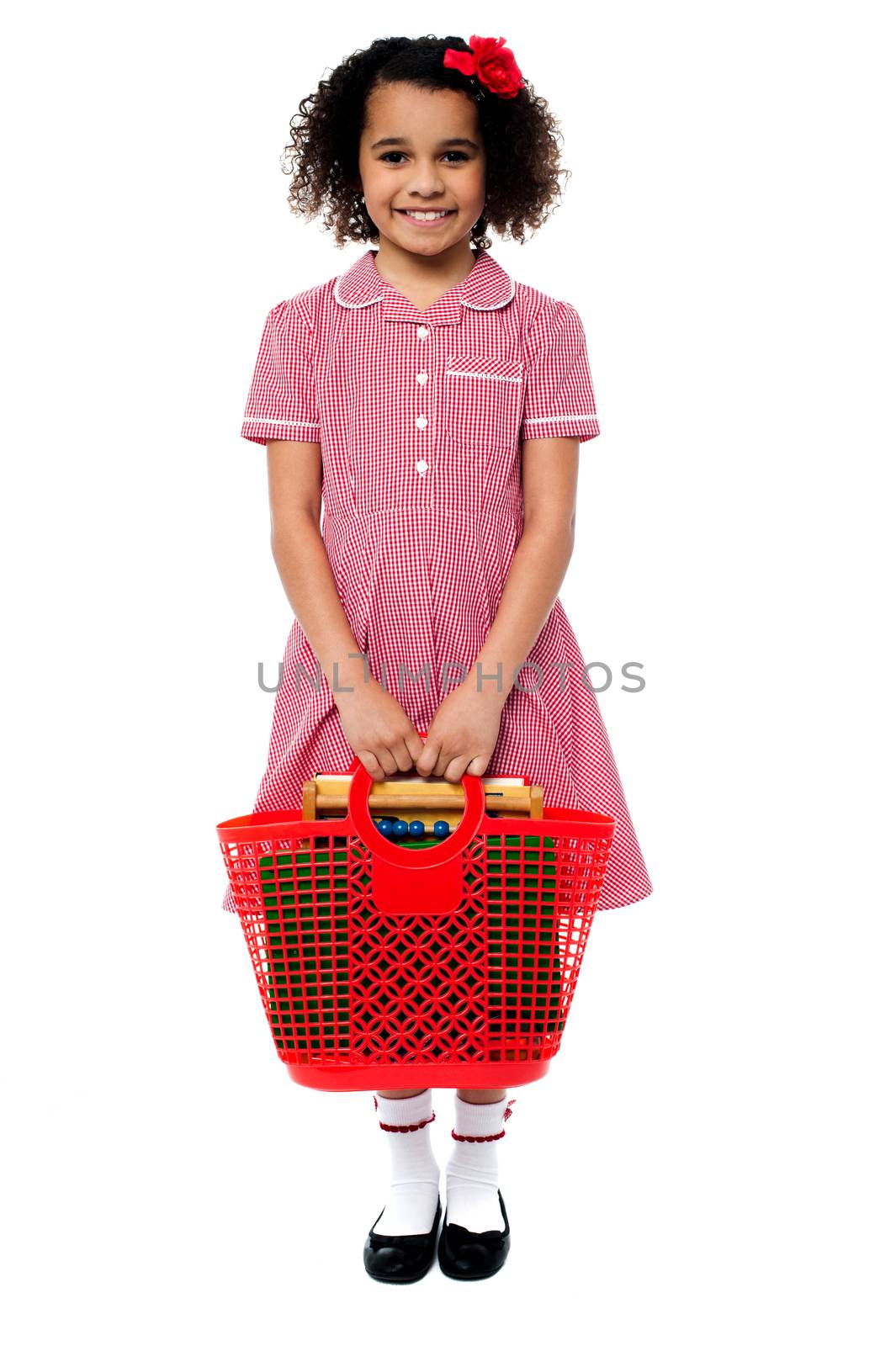 Smiling school girl carrying a basket bag