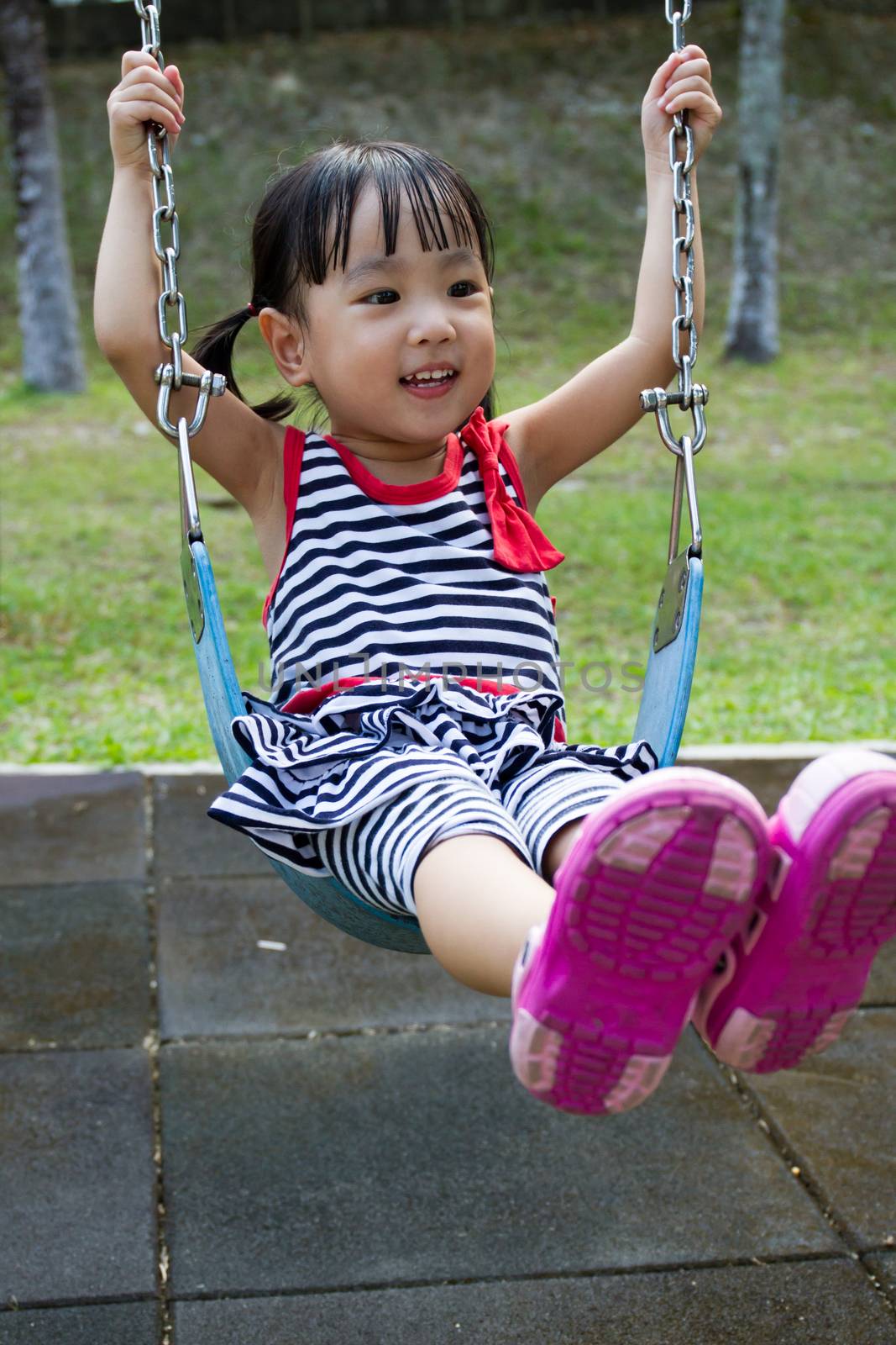 Asian Kid Swing At Park by kiankhoon
