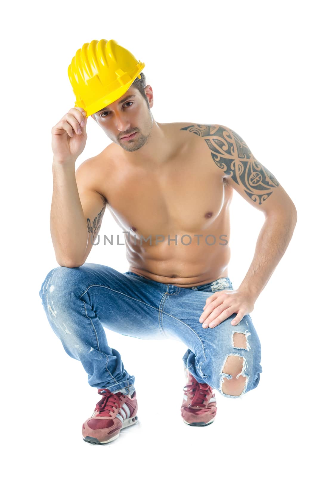 Handsome, muscular construction worker shirtless wearing jeans and hard hat, isolated on white