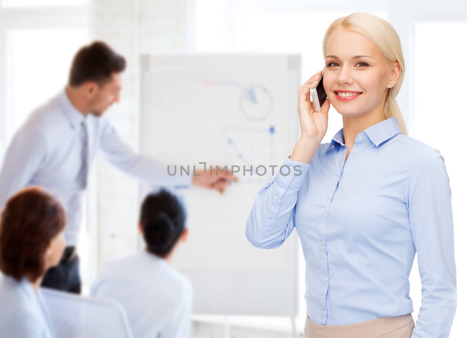 business, technology, education and people concept - smiling young businesswoman with smartphone making call in office