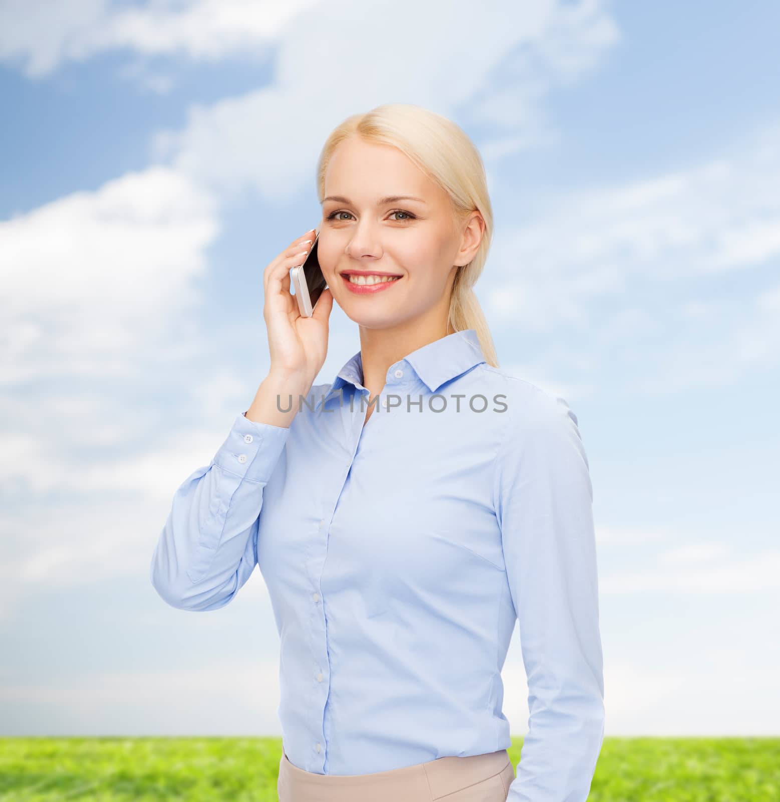 young smiling businesswoman with smartphone by dolgachov